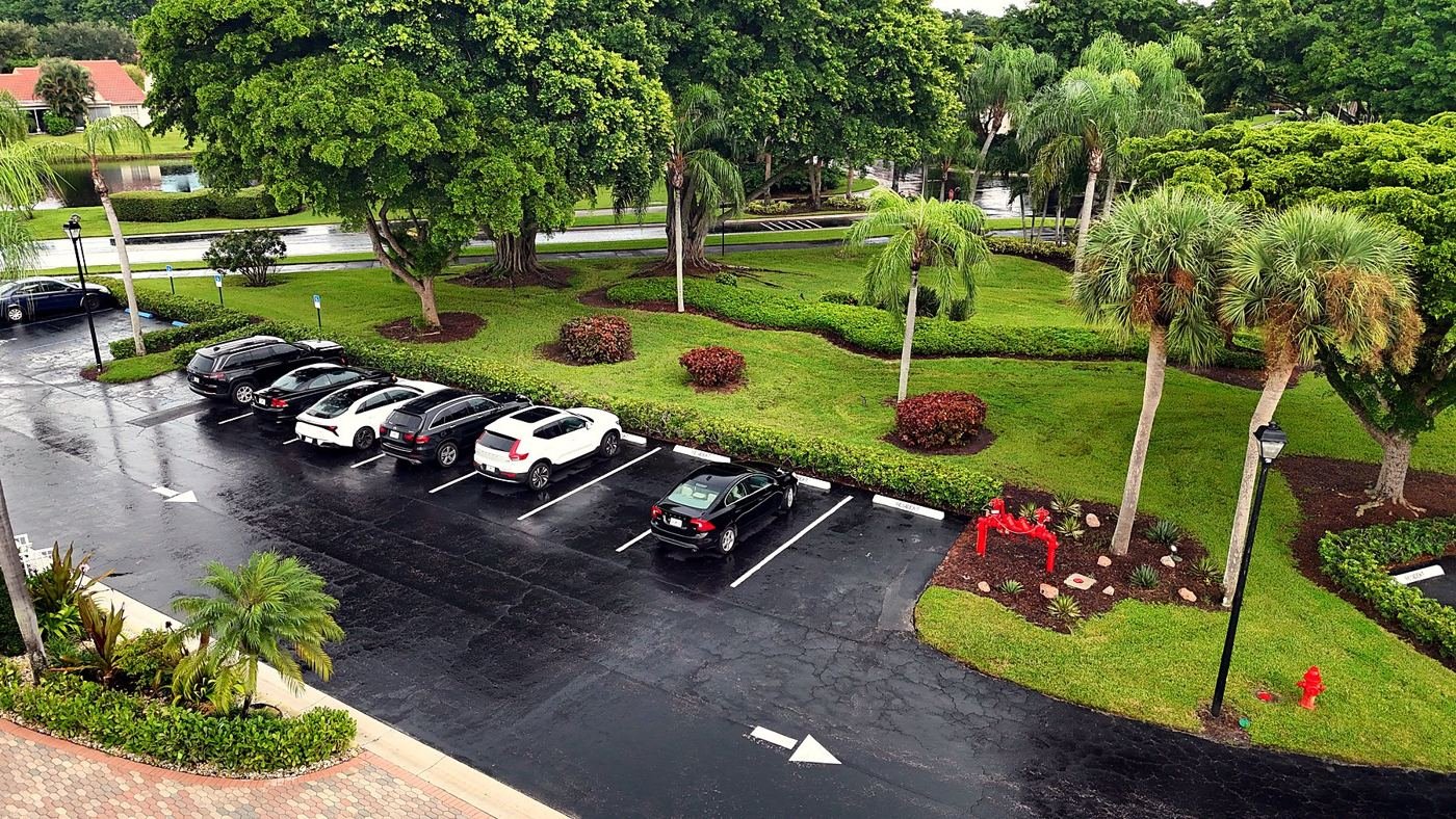 Aerial drone photo of a residential community's grounds, parking and landscaping